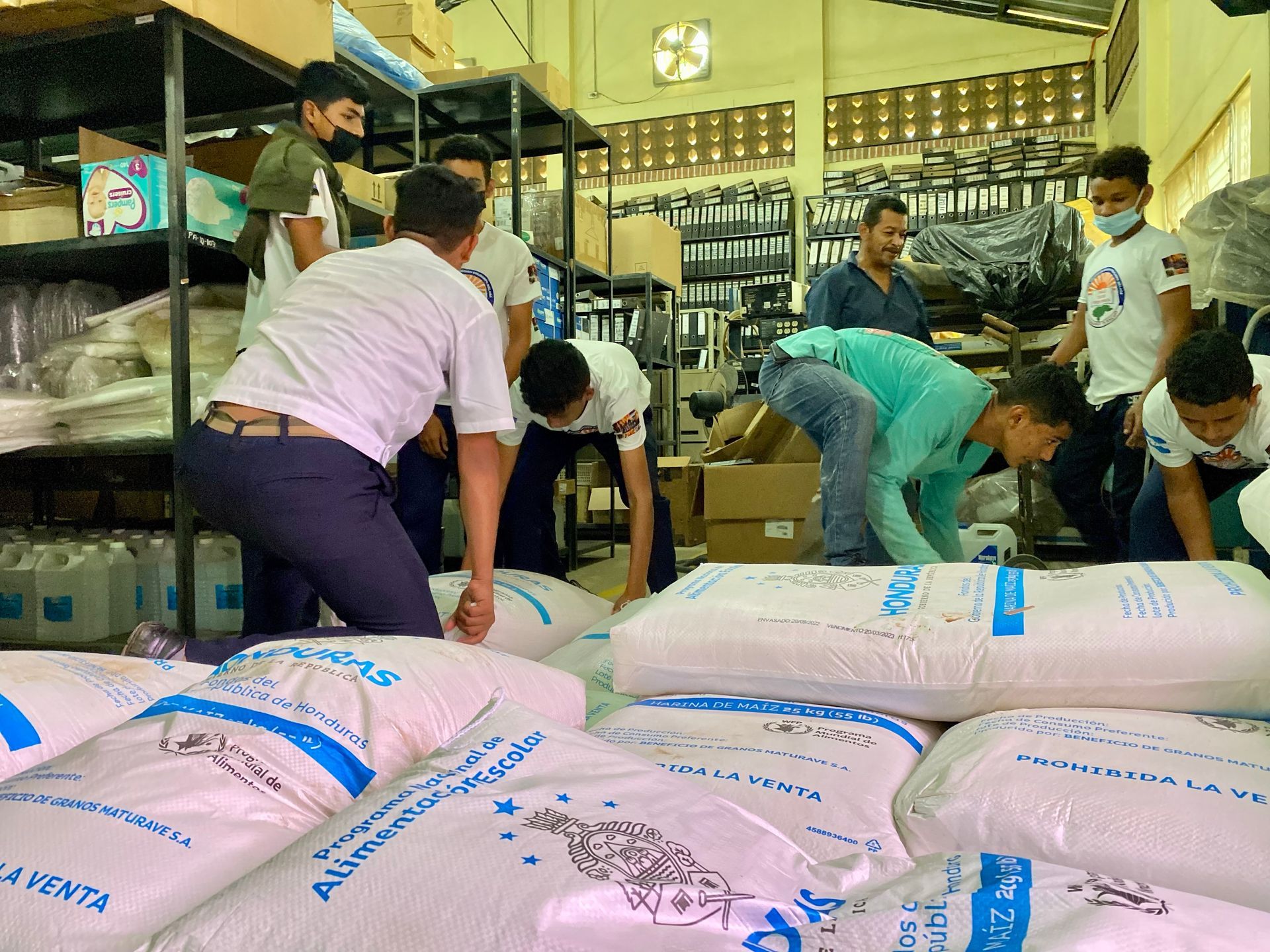 A group of men are working in a warehouse.