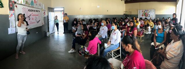 A large group of people are sitting in a room.