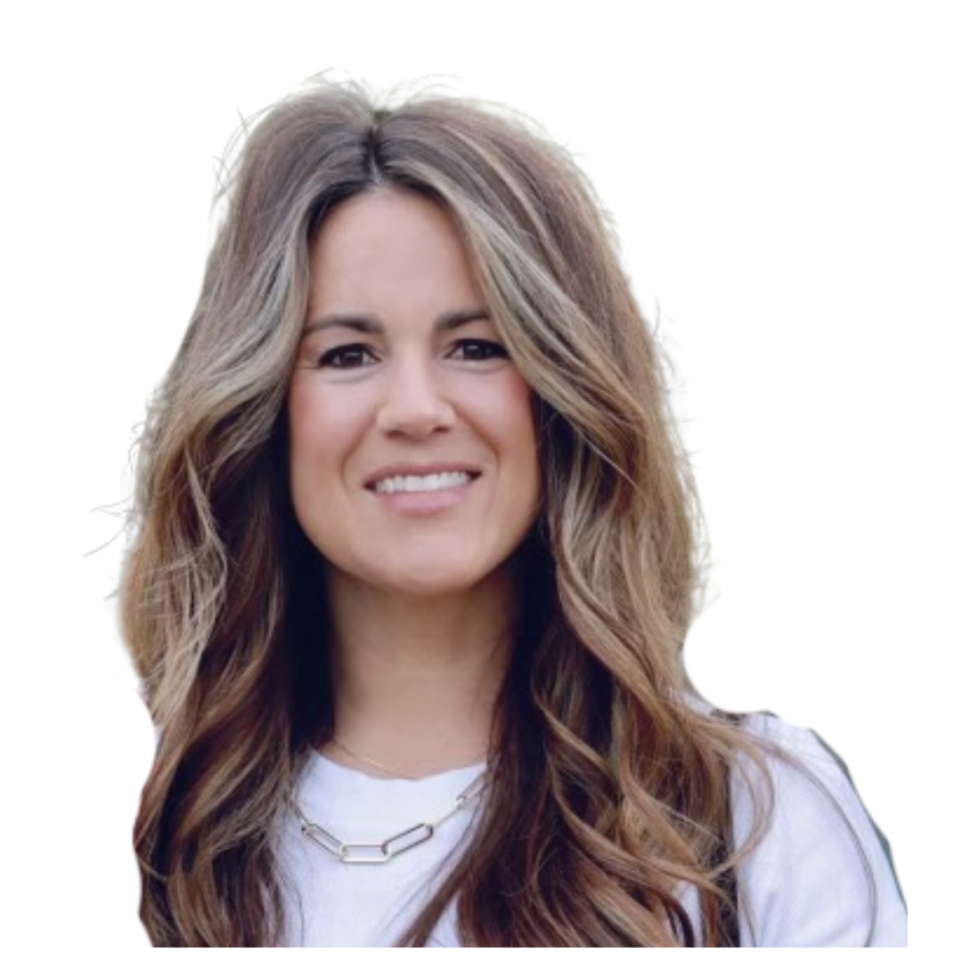 A woman wearing a floral dress and a white headband is smiling.