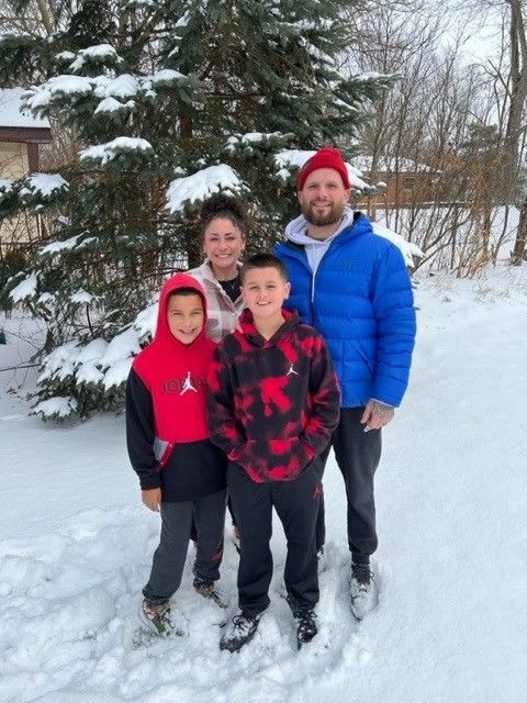 A family posing for a picture in the snow