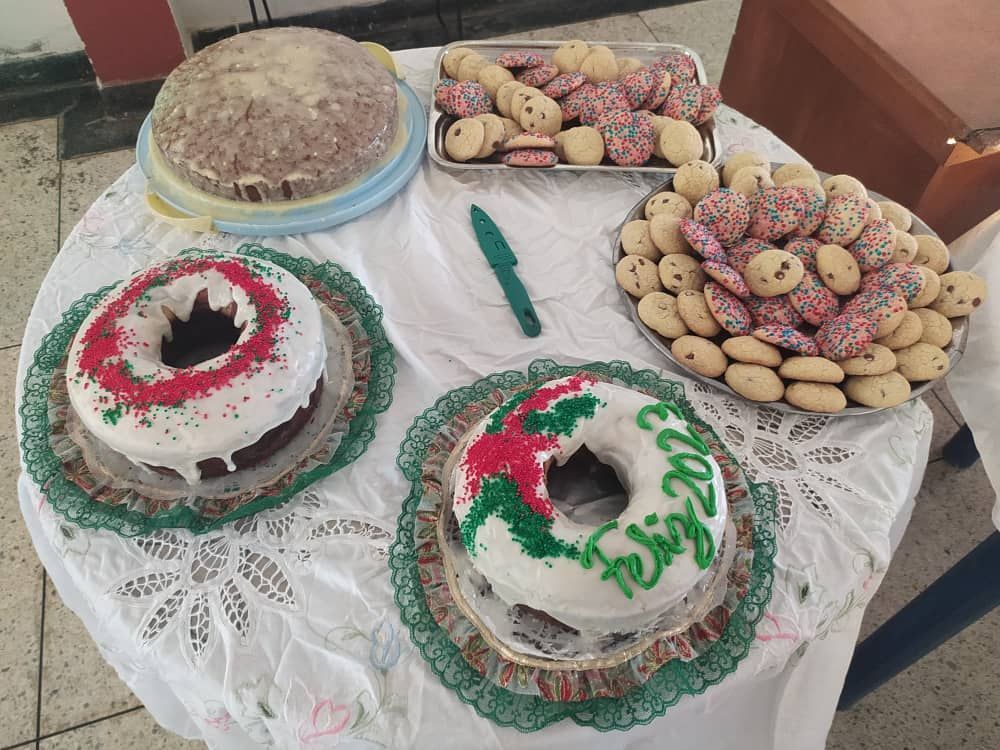A table topped with a variety of cakes and cookies.