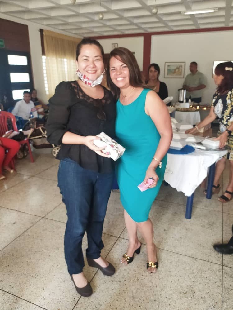 Two women standing next to each other in a room