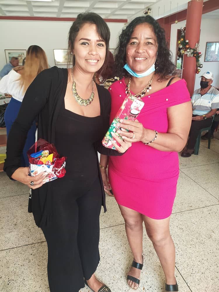Two women standing next to each other in a room