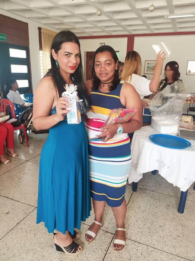 Two women are standing next to each other in a room.