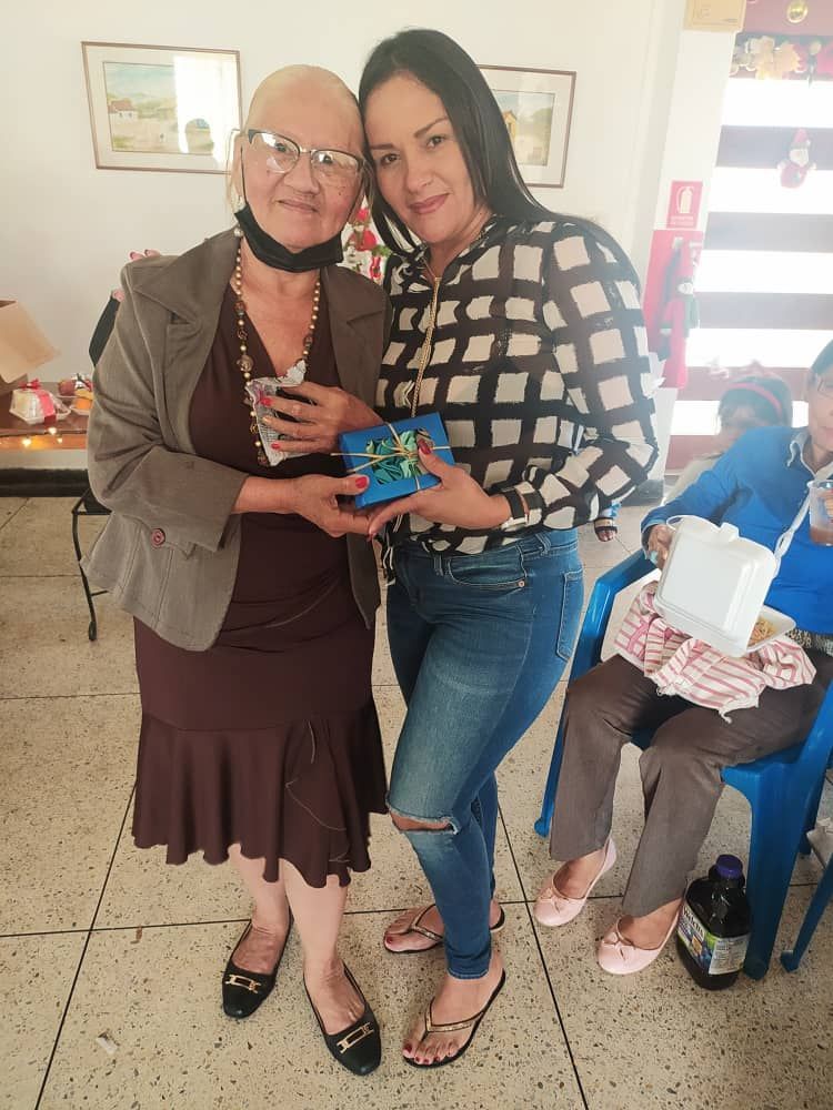 Two women are standing next to each other in a room.