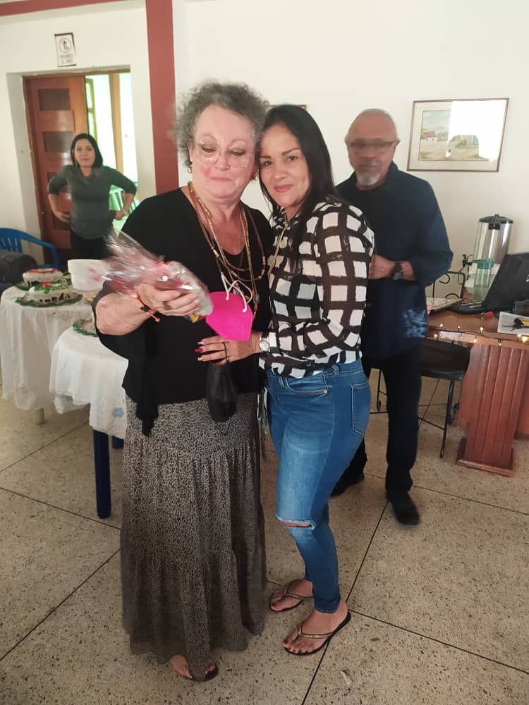 Two women are standing next to each other in a room.