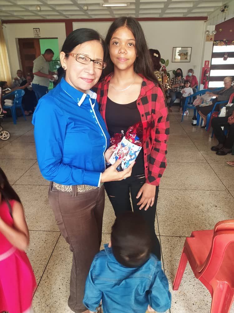 A woman and a girl are posing for a picture in a room.