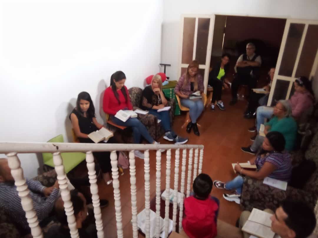 A group of people are sitting in a circle reading books
