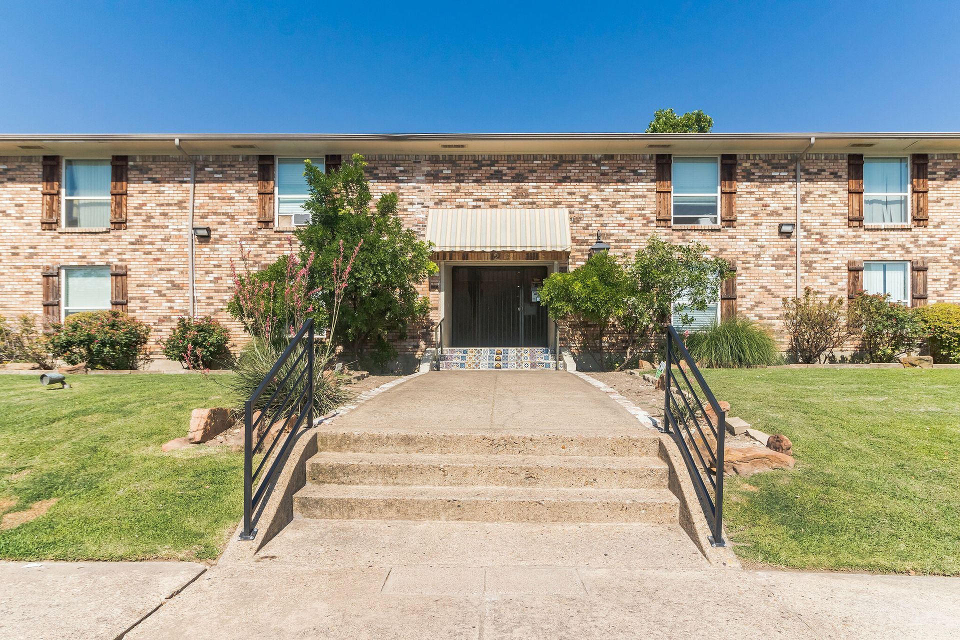 Photo of a two-story building, showing the steps leading up to the entrance