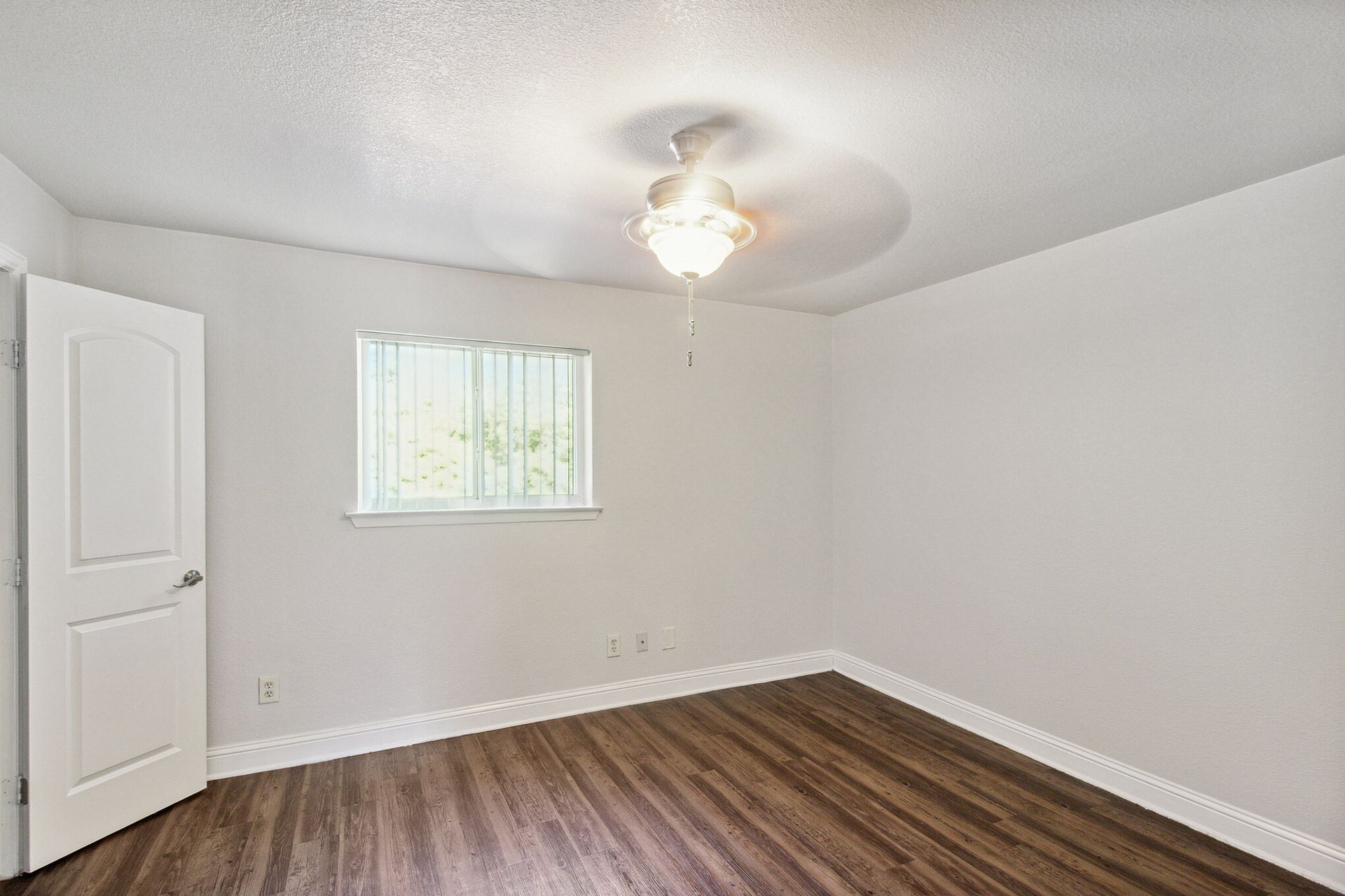 Photo of a medium-size bedroom with a ceiling fan