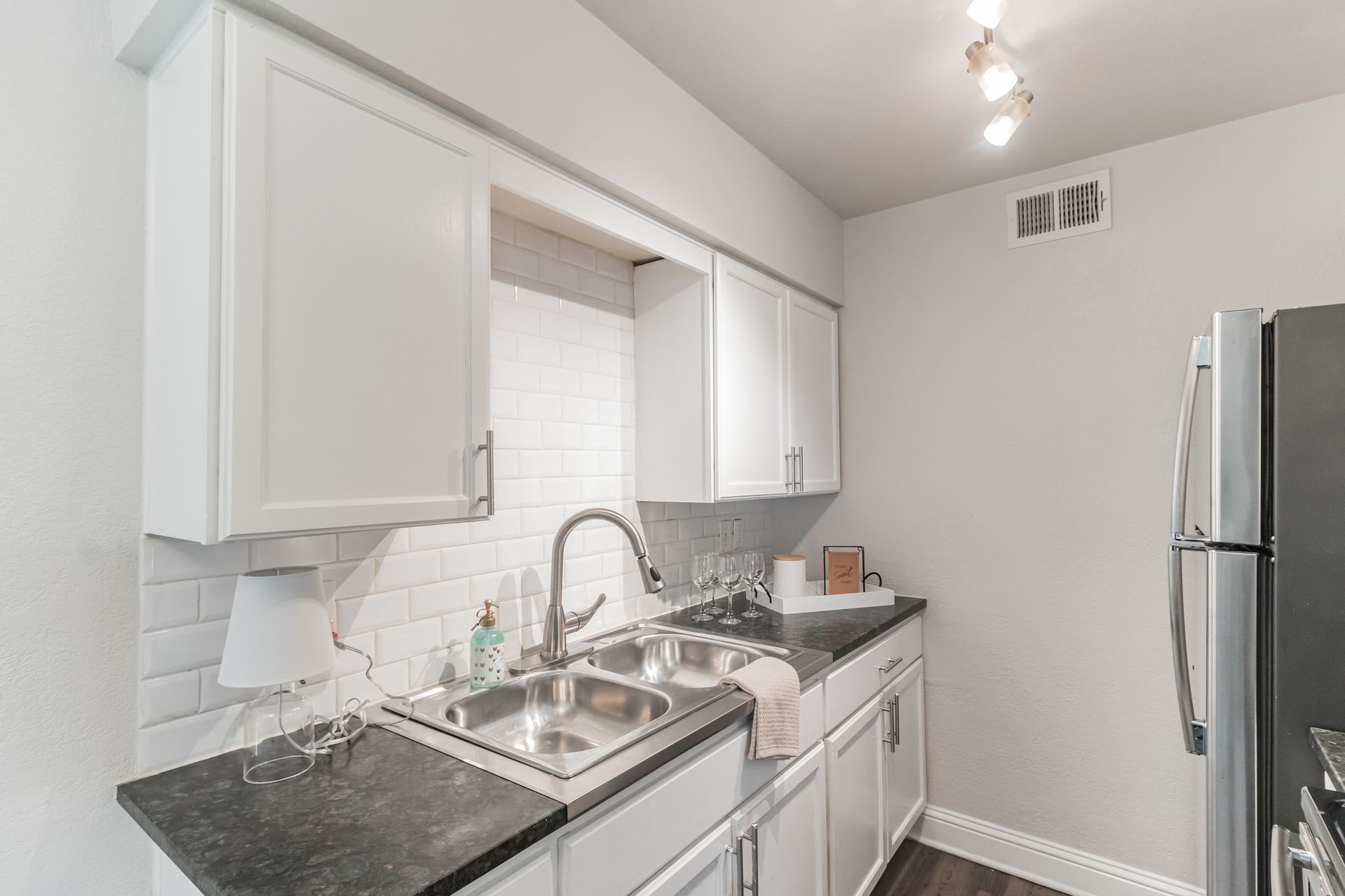 Photo of a sink with surrounding cabinets