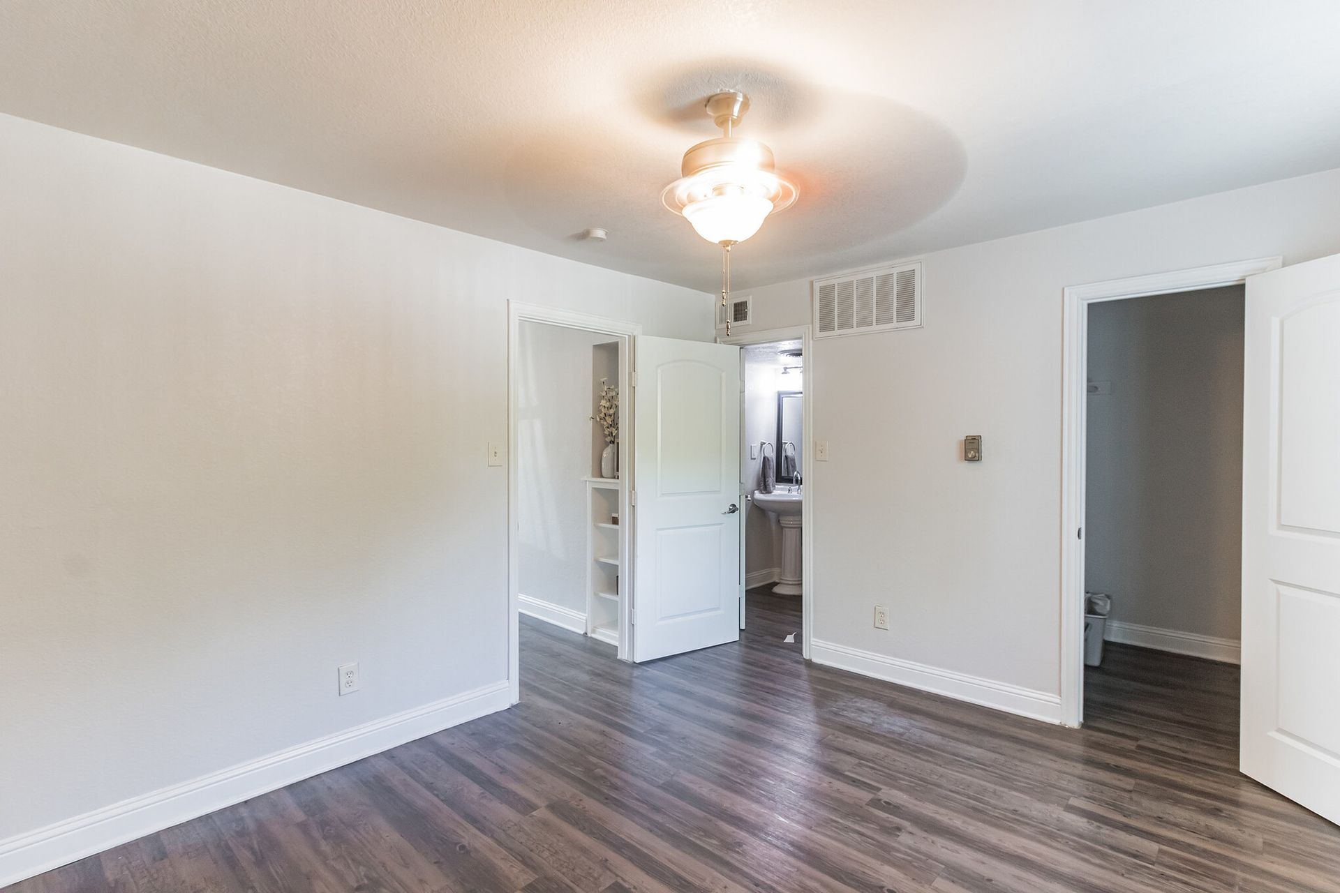 Photo of a room, showing various doors in the background