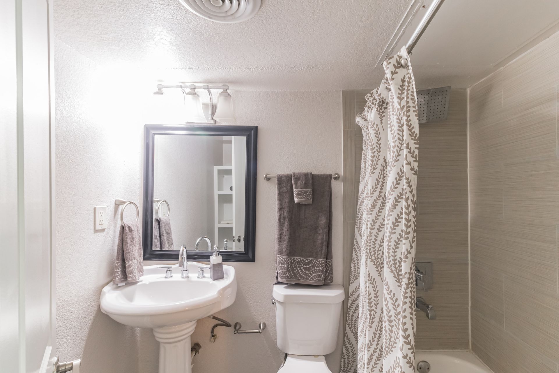 Photo of a bathroom with a bathtub/shower combination