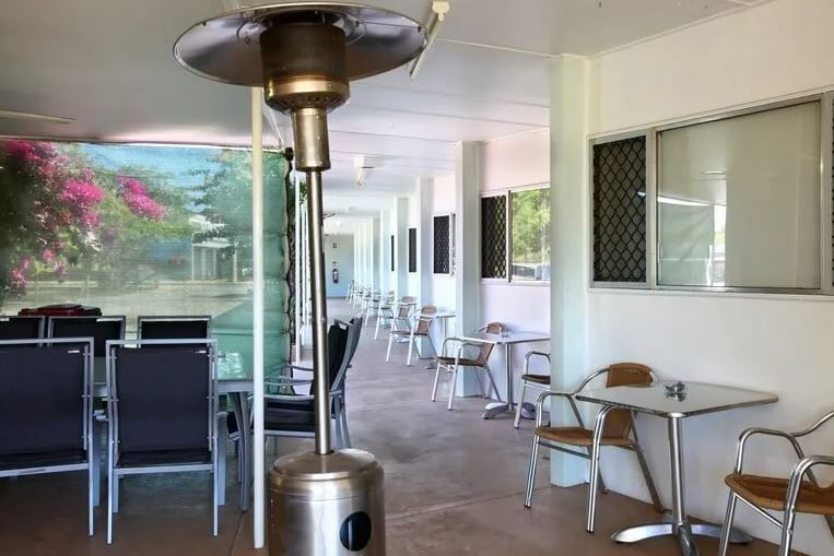Outdoor Cafe with Tables, Chairs and A Gas Heater — Fourth Avenue Motor Inn in Parkside, QLD