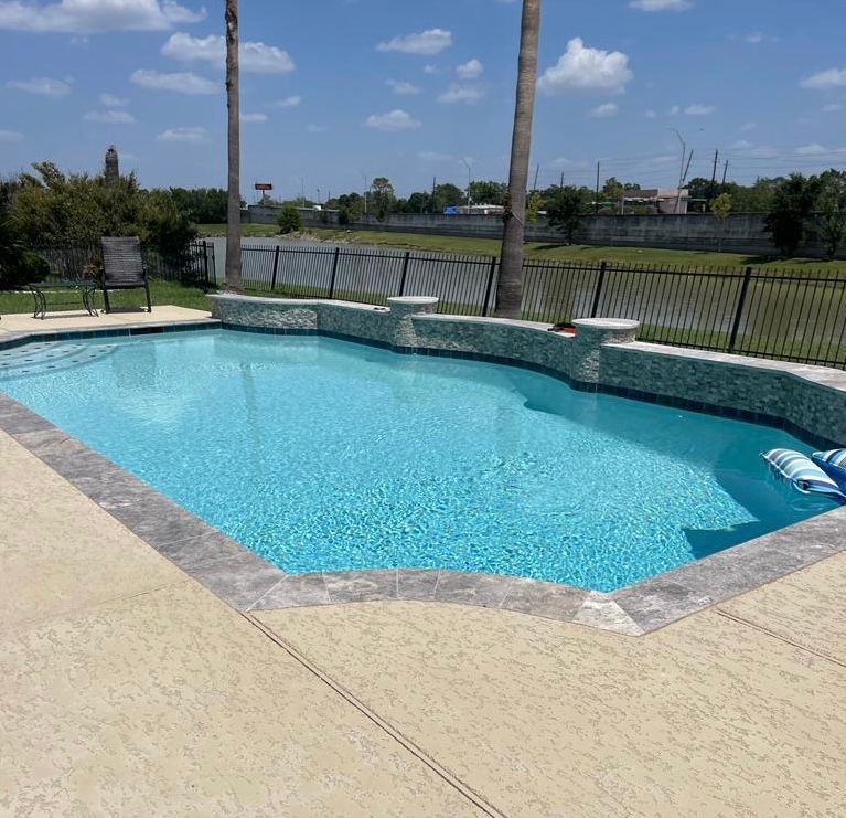 A large swimming pool with palm trees in the background