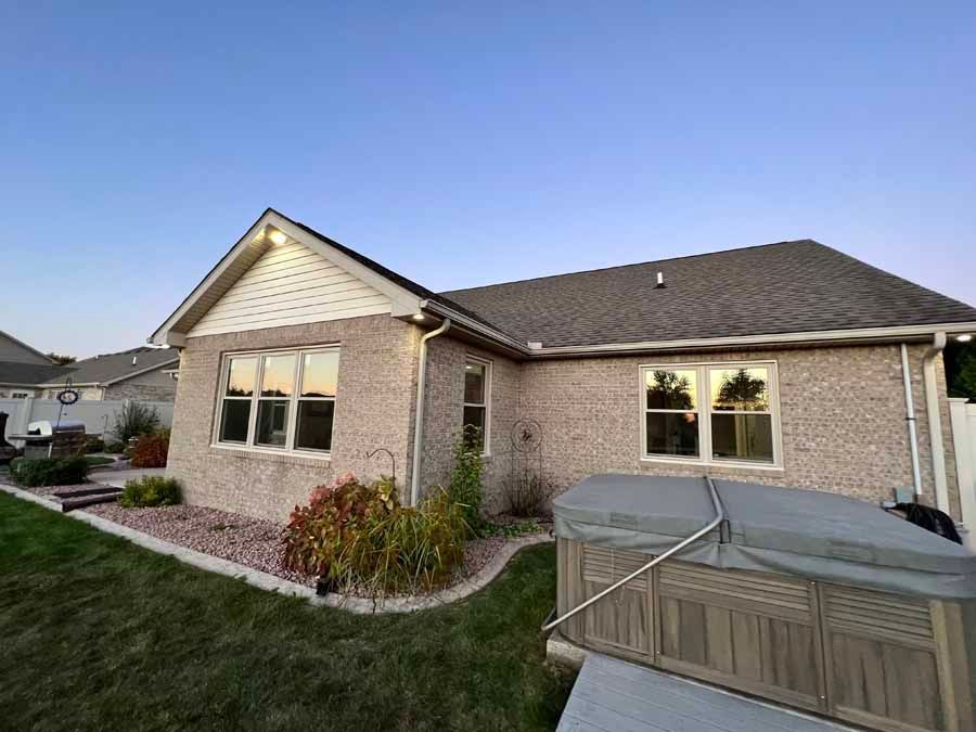 A house with a hot tub in the backyard.