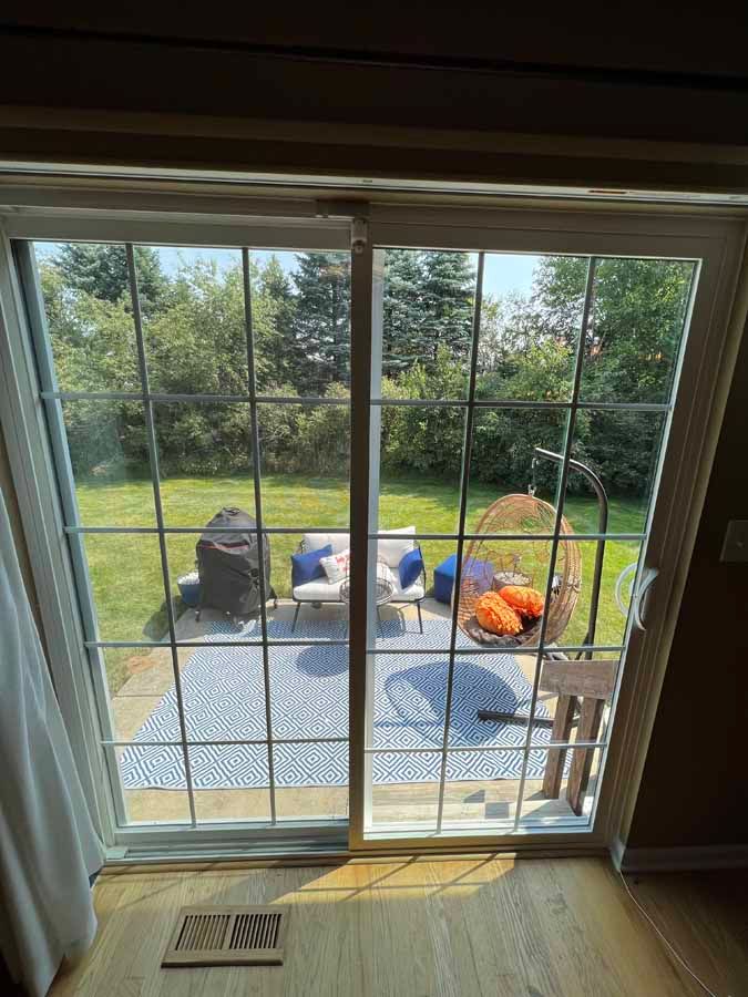 A view of a patio through a sliding glass door.