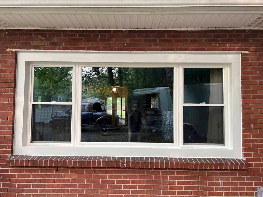 There is a large window on the side of a brick building.