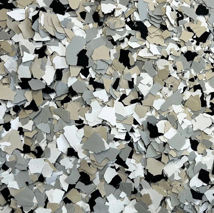 A close up of a pile of gray white and black flakes