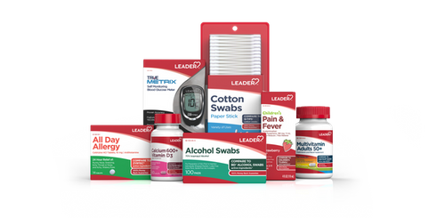 Assortment of LEADER brand medicine boxes, including nicotine patches, cough drops, and allergy relief, on a white surface.