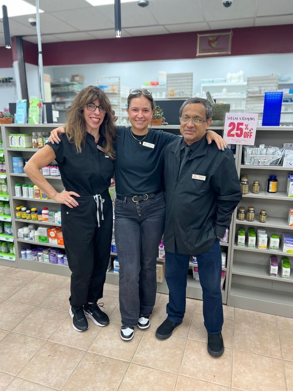 Building with stone facade and American flag; snow on the ground; sunny day.