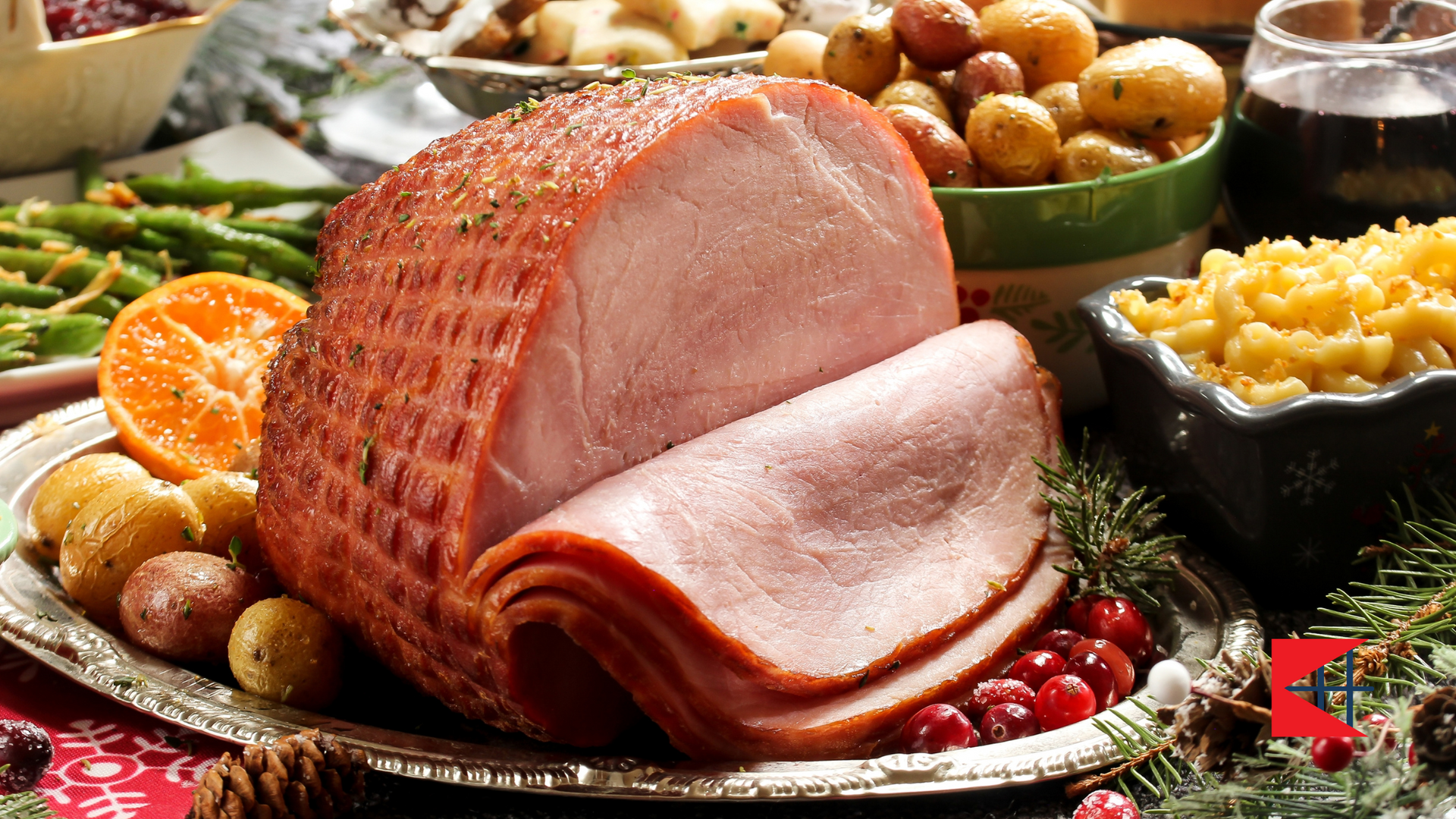 A plate of ham , potatoes , green beans and macaroni and cheese on a table.