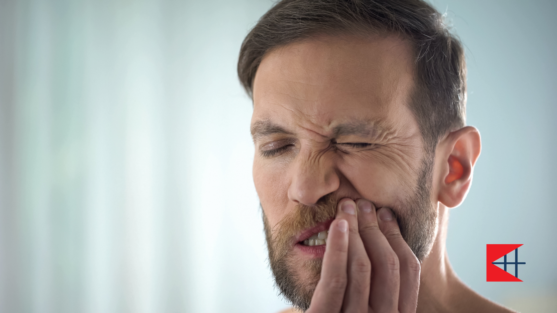 A woman is covering her mouth with her hands.