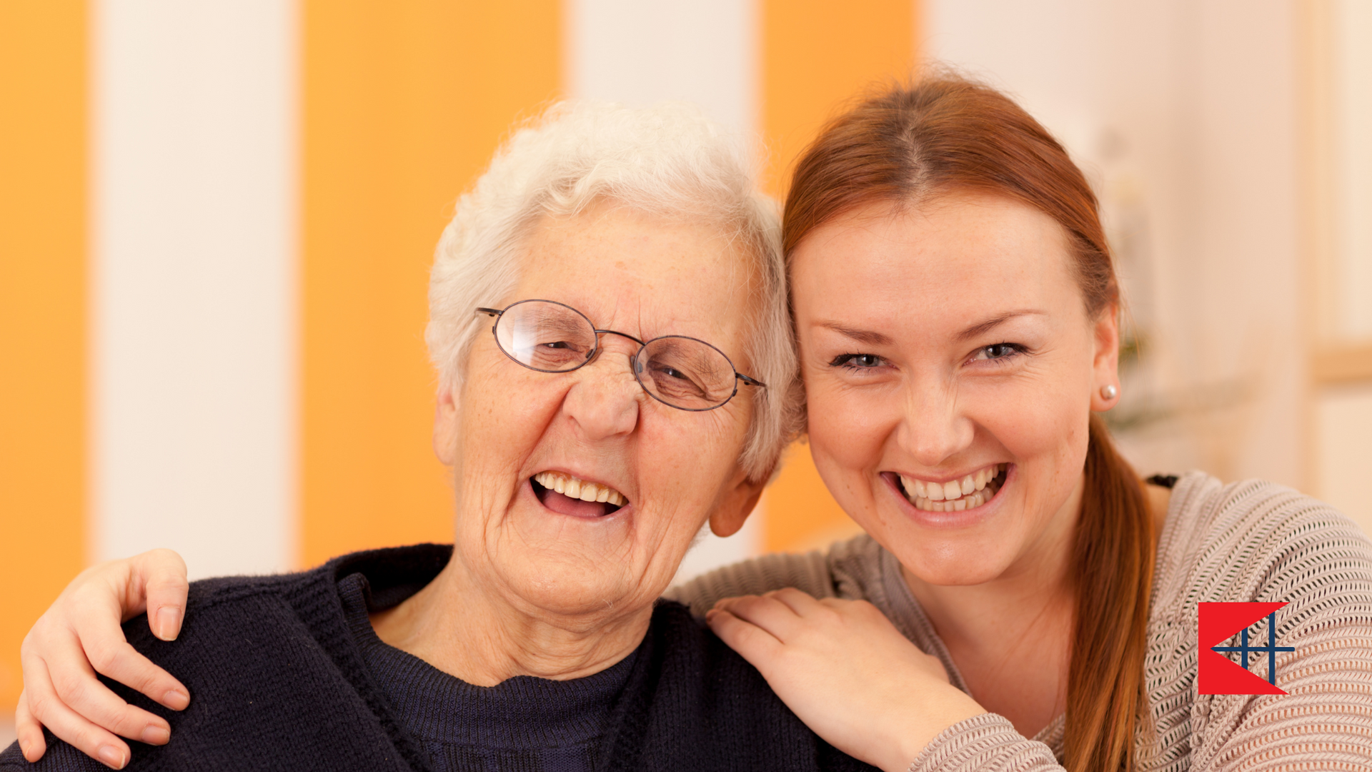 A young woman is hugging an older woman and they are smiling for the camera.