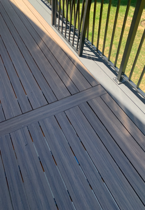 A patio with a couch two chairs and a coffee table
