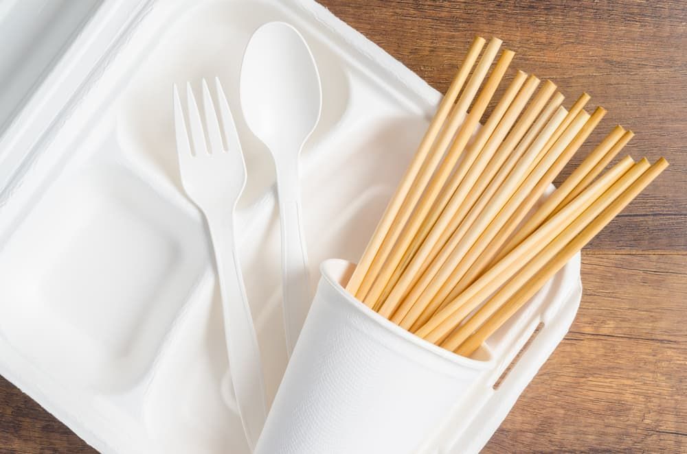 A styrofoam container with a spoon , fork and straws in it — Springs Cleaning Supplies In Ciccone, NT
