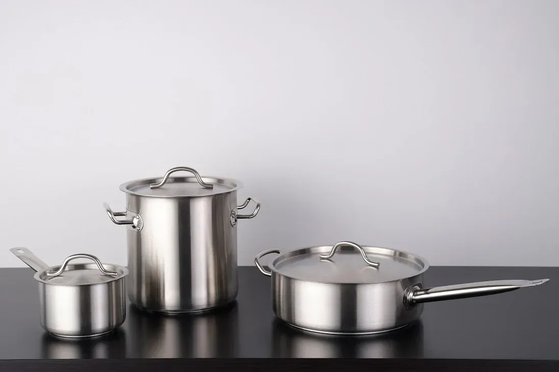 Three Stainless Steel Pots And Pans Are Sitting On A Black Table — Springs Cleaning Supplies In Ciccone, NT