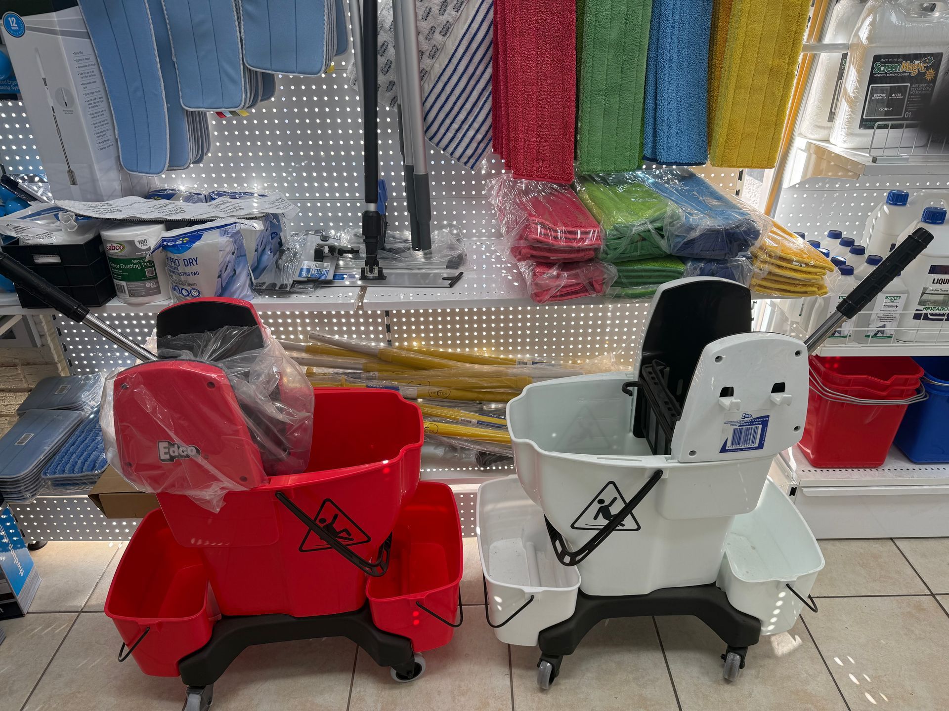 A Woman Is Cleaning A Stainless Steel Grill With A Cloth — Springs Cleaning Supplies In Ciccone, NT