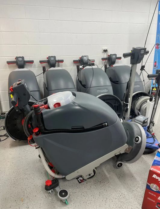 A Bunch Of Cleaning Machines Are Sitting On The Floor In A Room — Springs Cleaning Supplies In Ciccone, NT