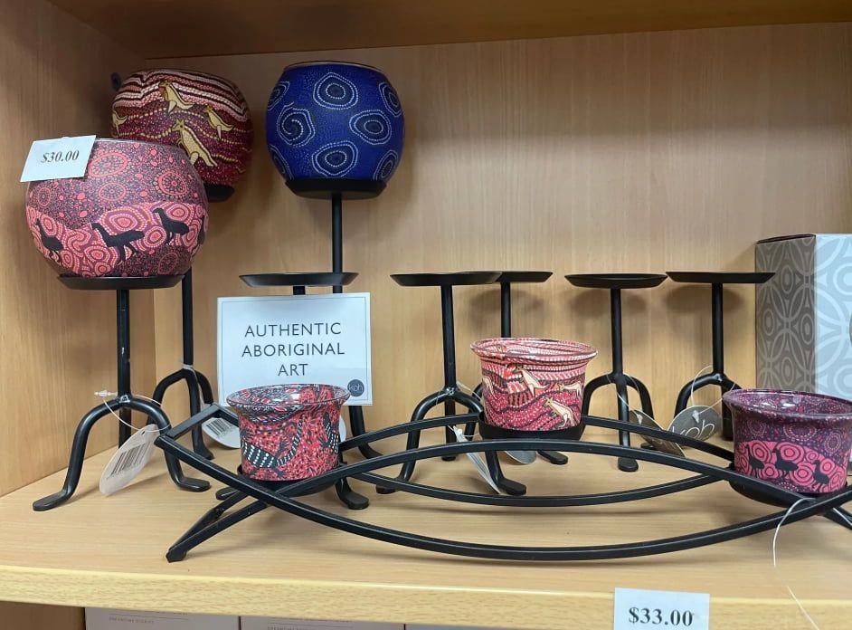 A Shelf With Candle Holders And A Sign That Says Authentic Aboriginal Art — Springs Cleaning Supplies In Ciccone, NT