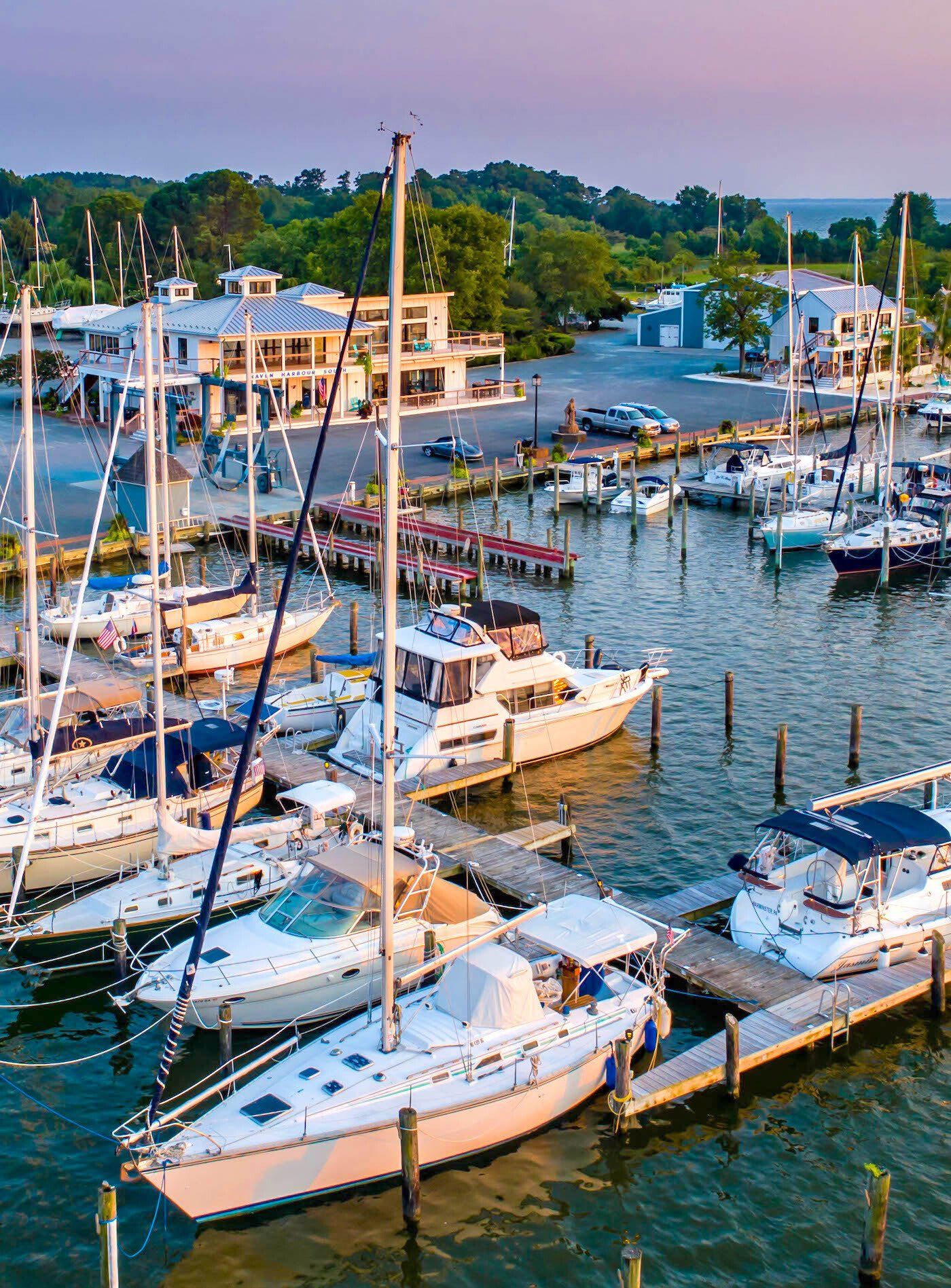 Aerial view of marina at sunset with sailboats and docks