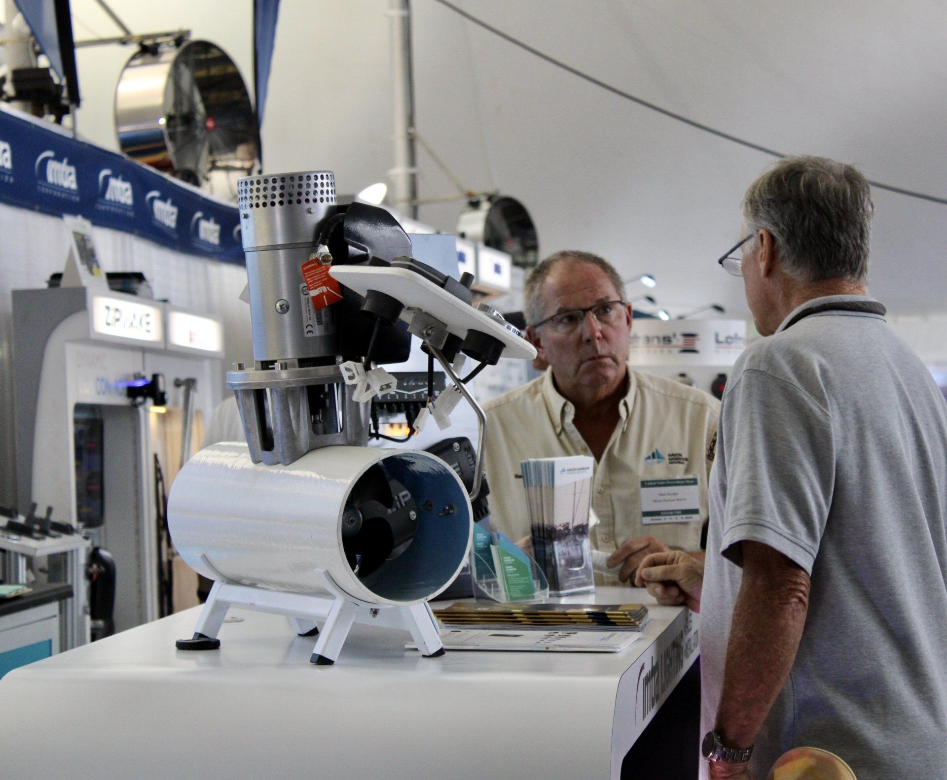 Marina employee speaking with boat show attendee