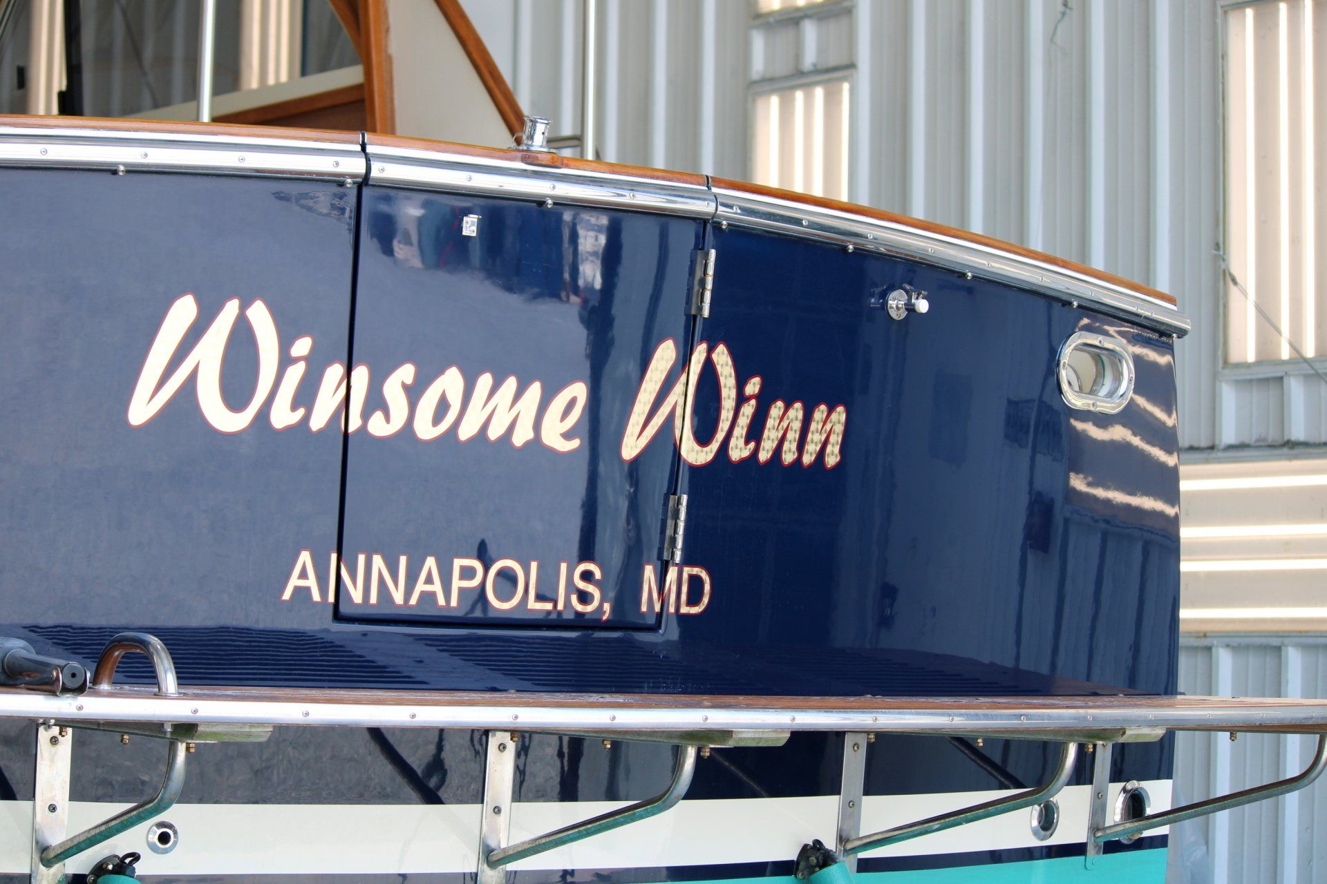Close-up of paint work on the boat with its name Winsome Winn in view
