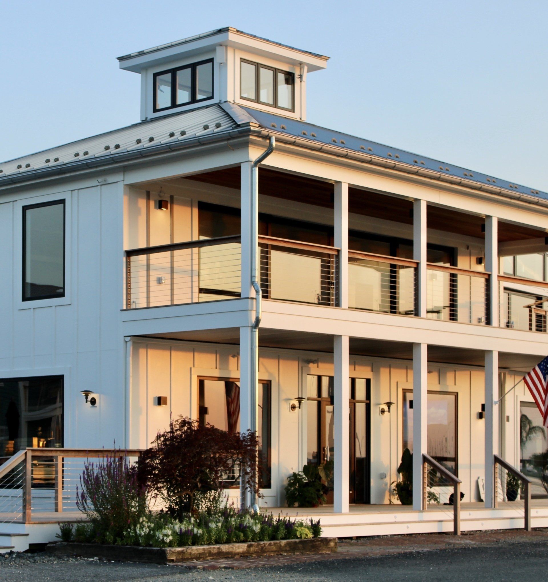 Modern white building with windows, doors and balcony