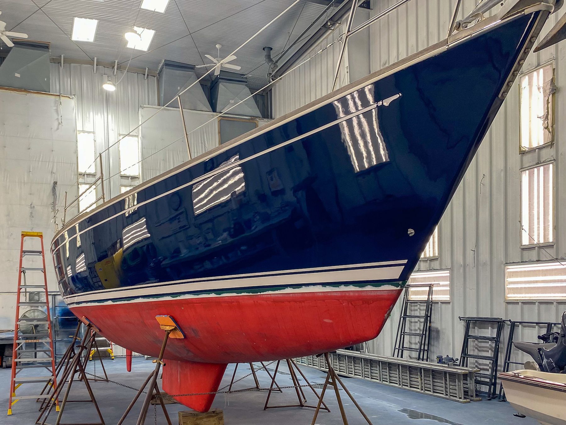 Blue boat inside lighted indoor paint shop