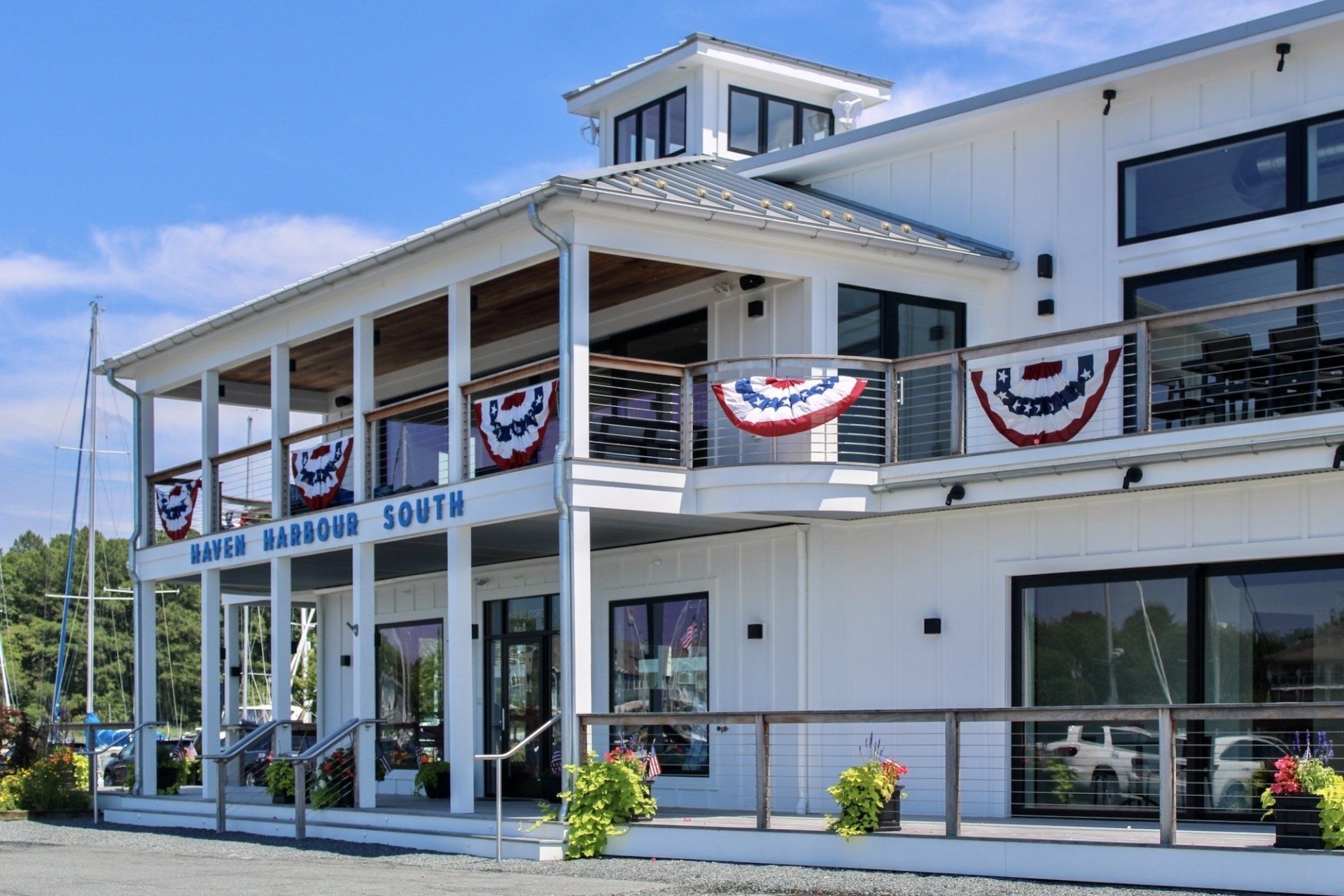 Outdoor scene of white modern building with porch and balcony
