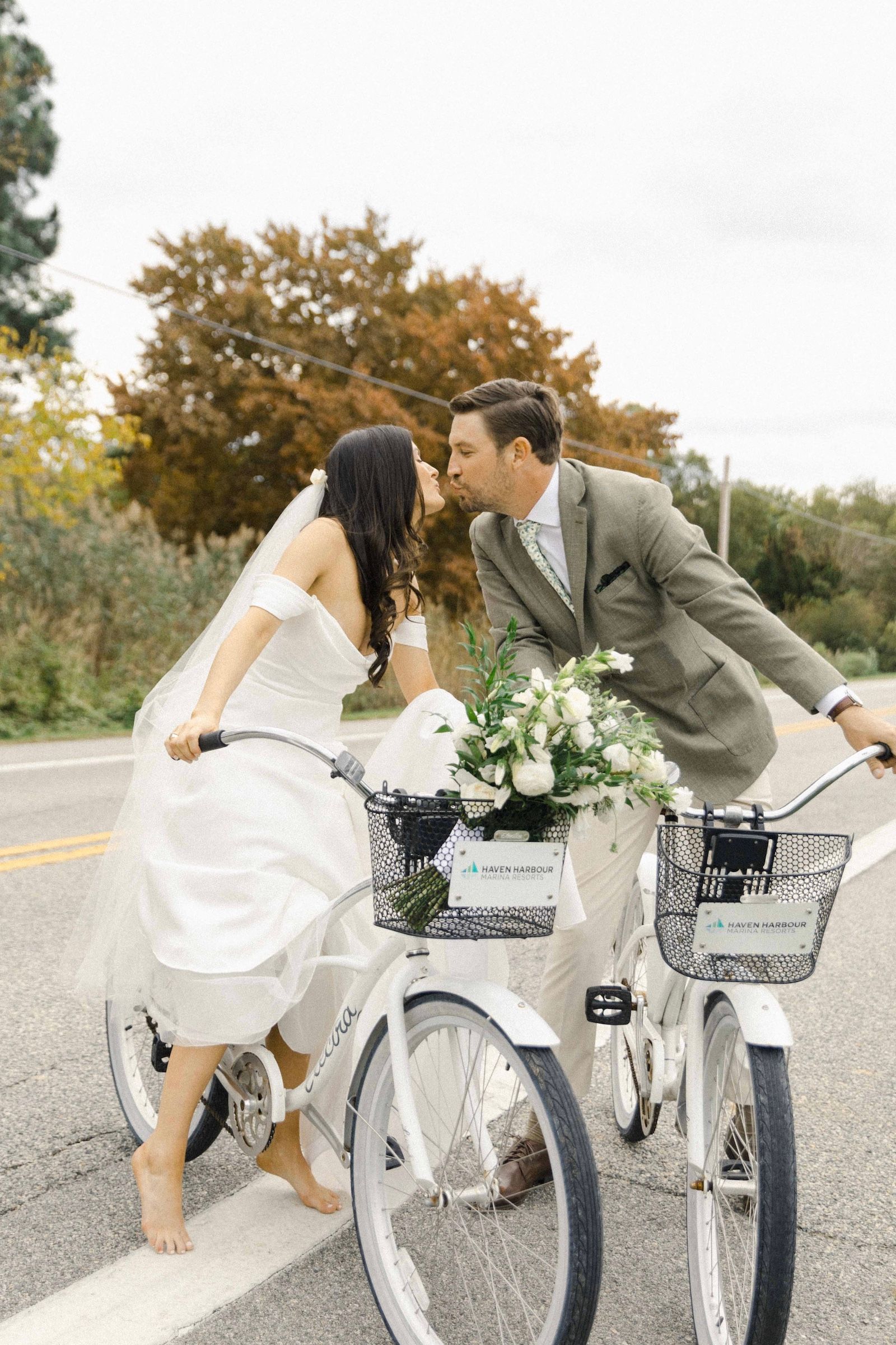 Wedding couple kissing on pair of bicycles
