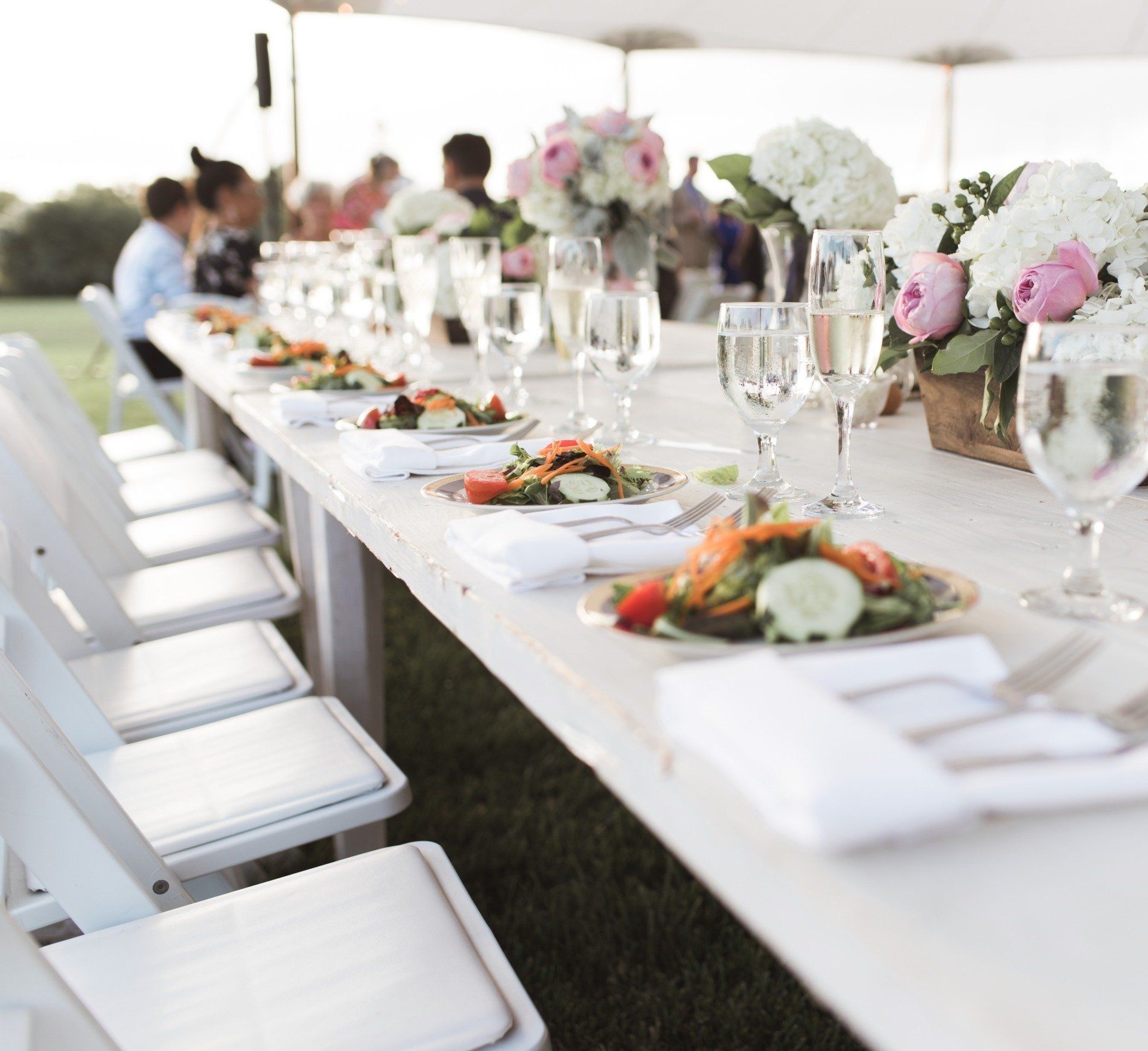 Dining table at a wedding with plates, glasses and silverware
