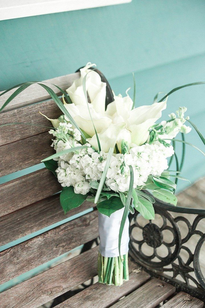 White flowers in a bouquet on a wooden bench