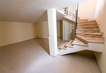 An empty room with stairs leading up to the second floor.