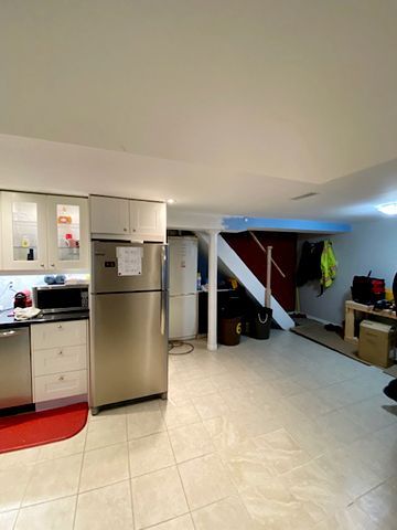 A kitchen with a refrigerator , dishwasher , and microwave.