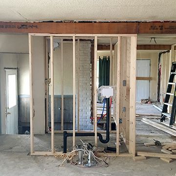 A room with a wooden frame and a ladder in it.