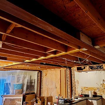 A room with a wooden ceiling and a lot of boxes on the floor.