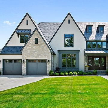 A large white house with a gray garage door