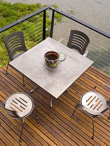 A wooden deck with a table and chairs on it