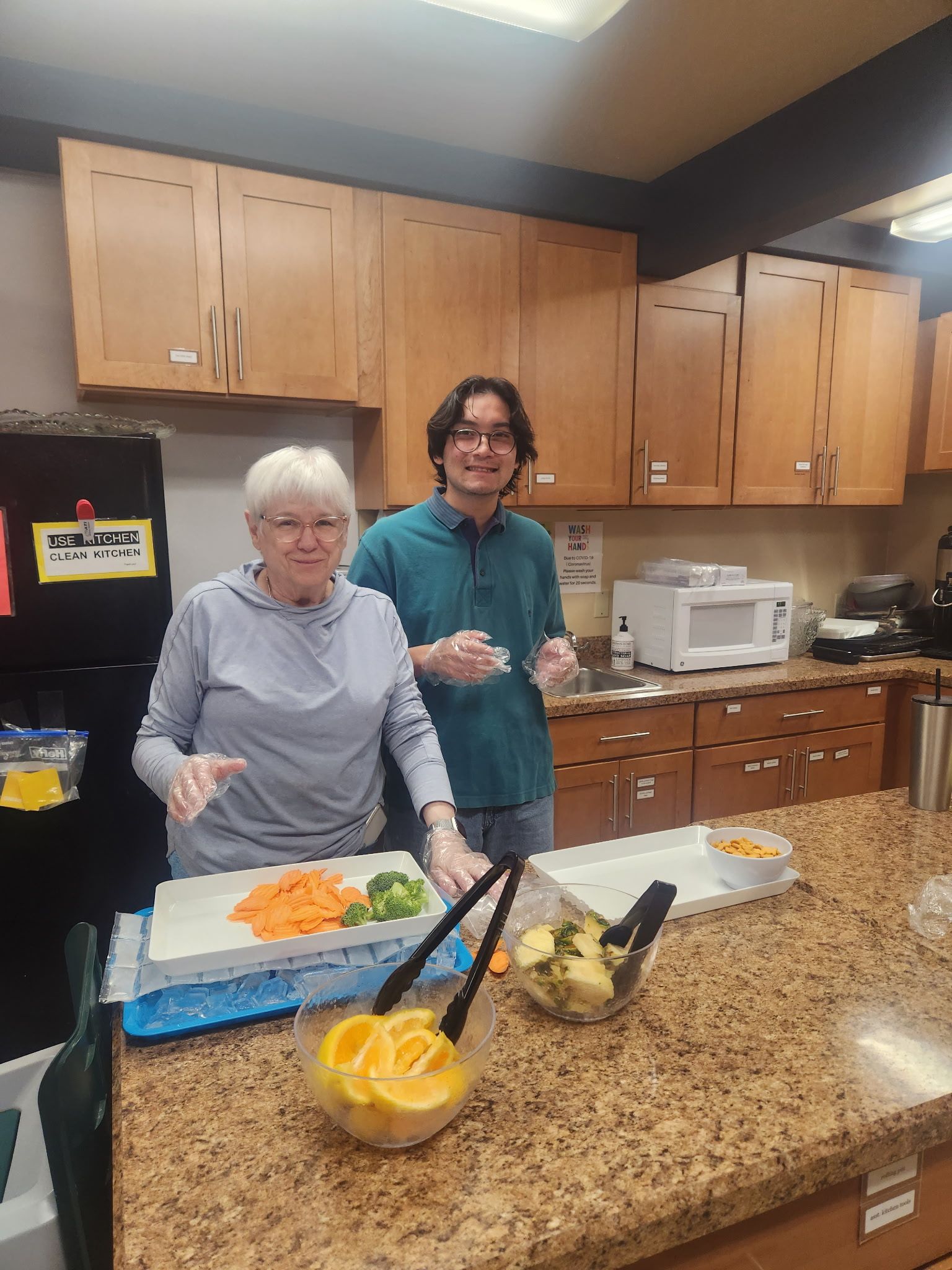 Two members of St. Matthew's preparing food for the church's lunch program.